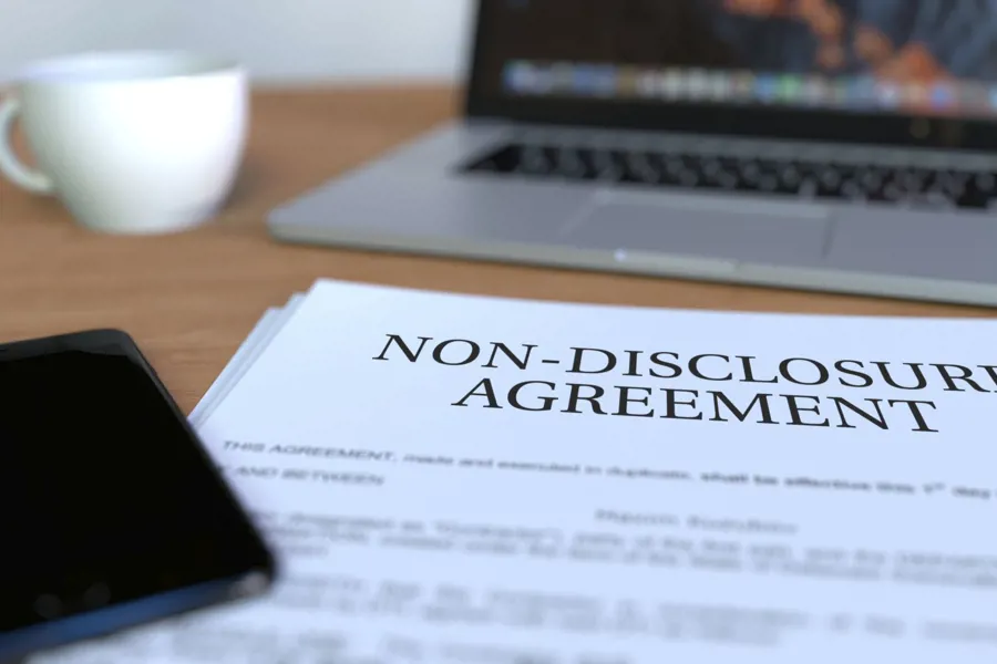 A laptop and a non-disclosure agreement in front