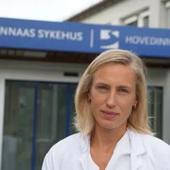 Female doctor in front of hospital entrance