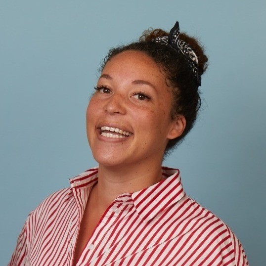 A person smiling with a ponytail