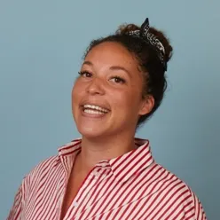 A person smiling with a ponytail