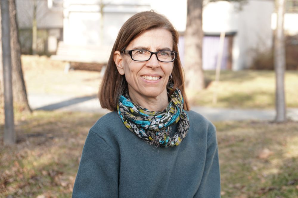 A woman wearing glasses and a scarf