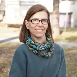 A woman wearing glasses and a scarf