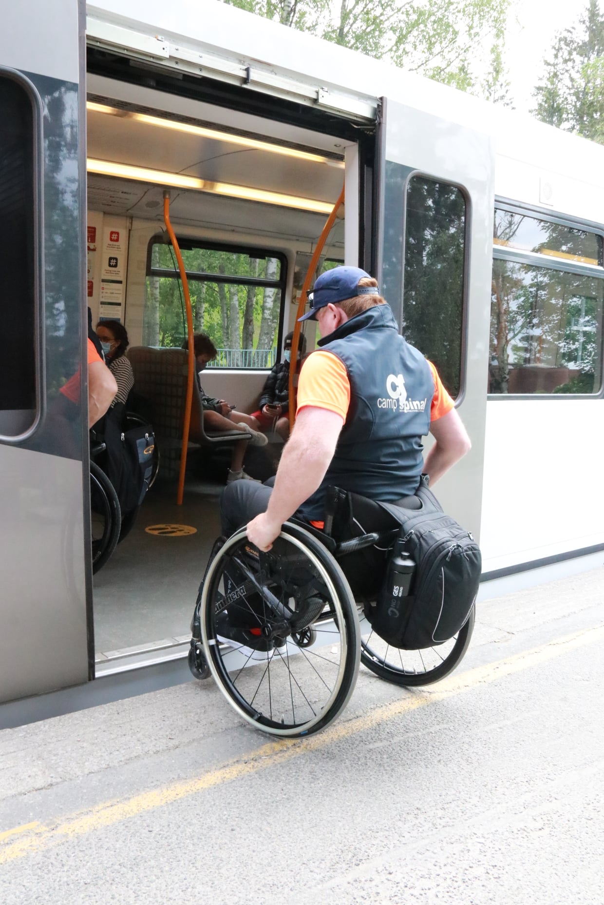 A person in a wheelchair getting on a bus