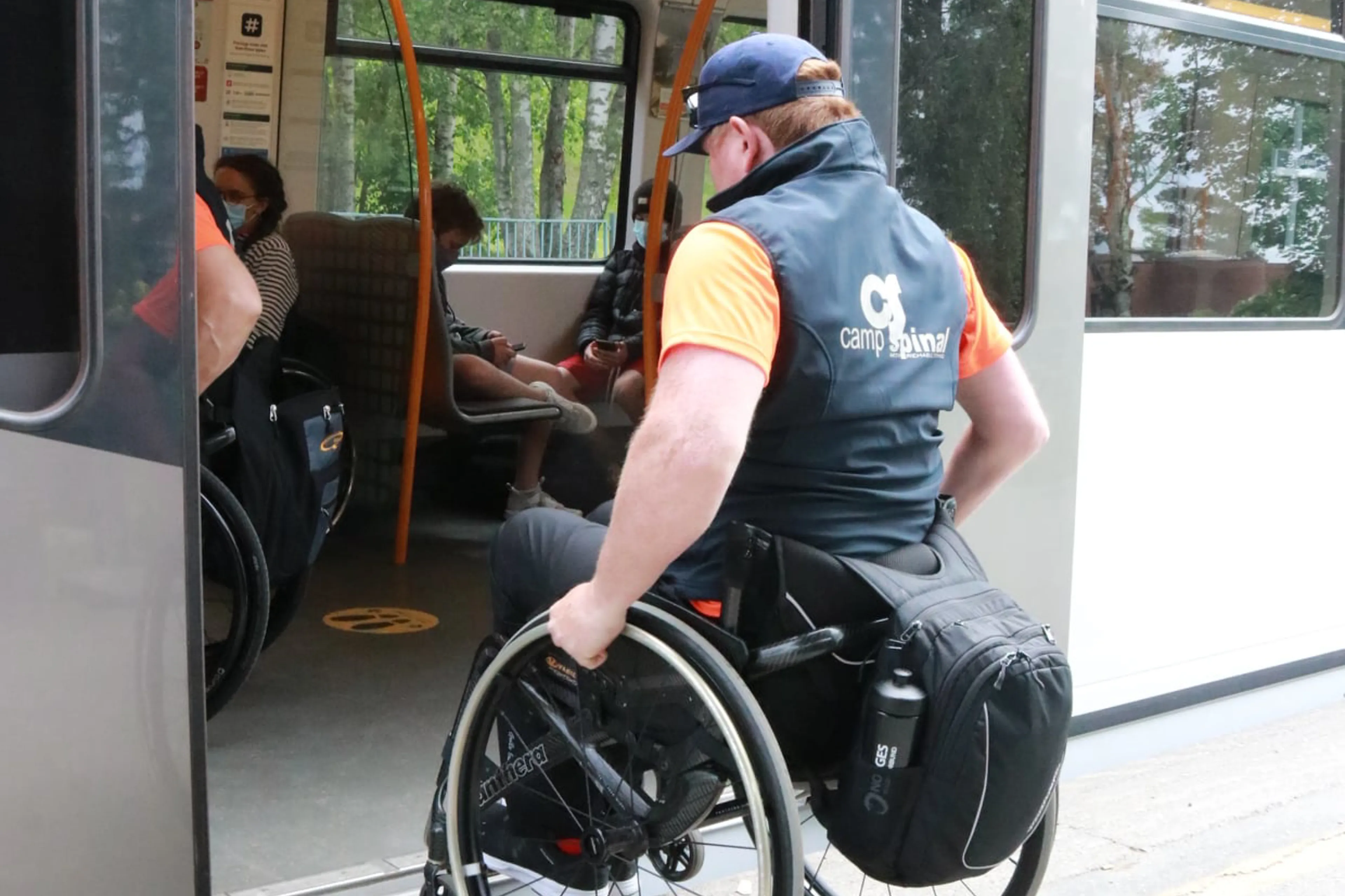 A person in a wheelchair getting on a bus