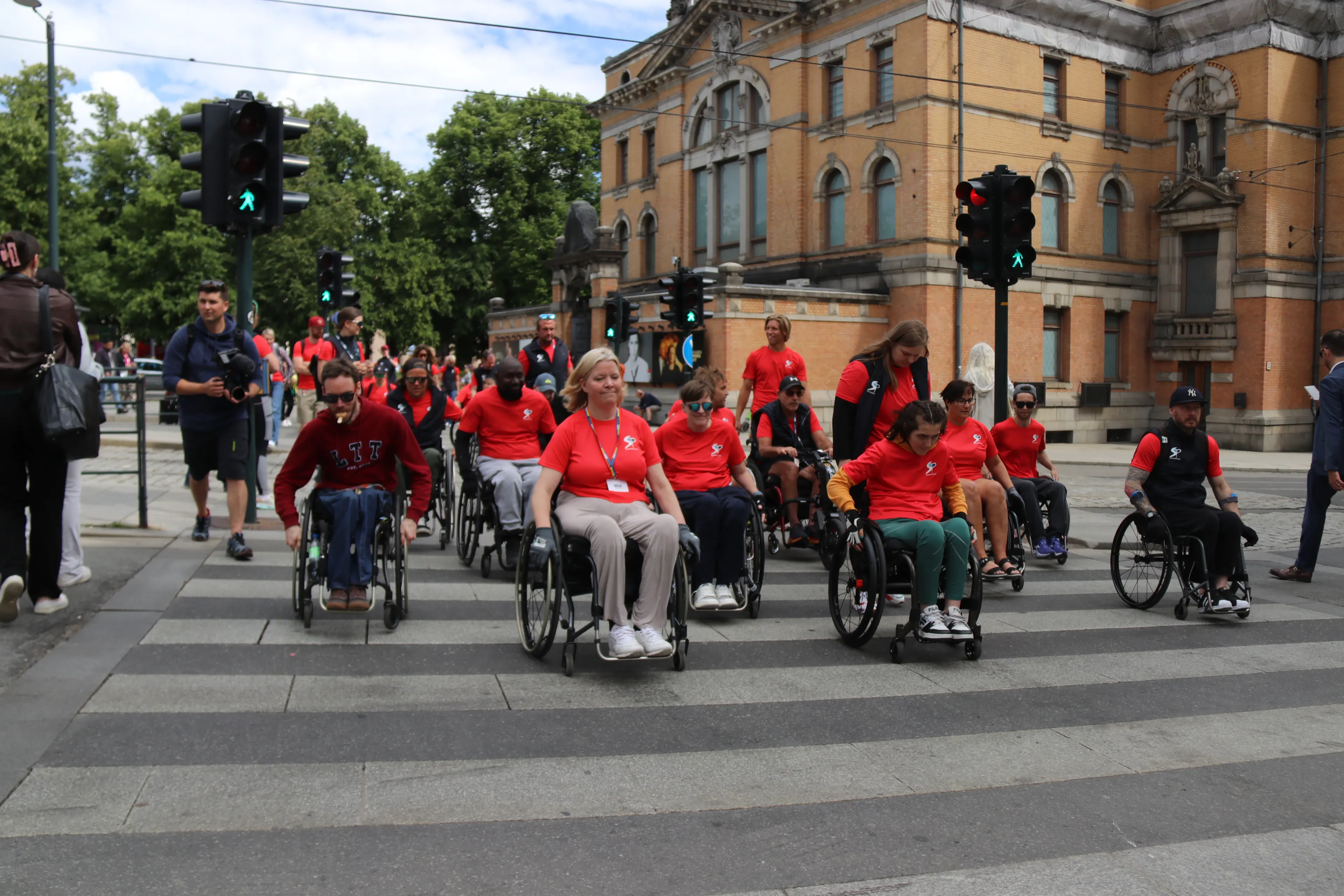 A group of people in wheelchairs on a street