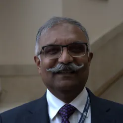A man with a mustache and glasses