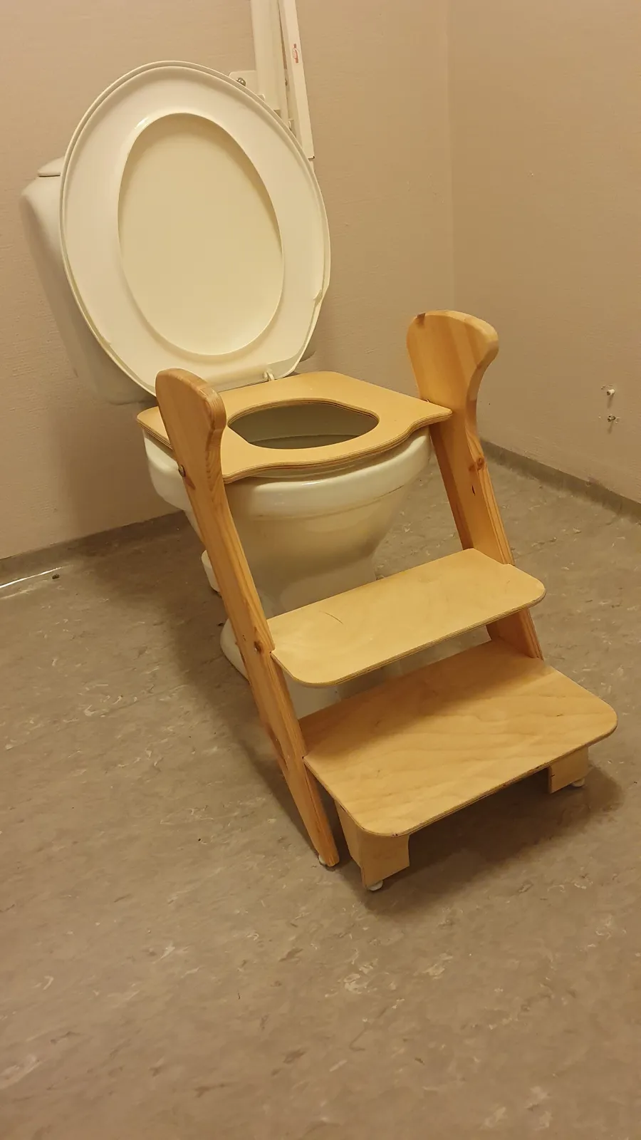A toilet with a wooden seat