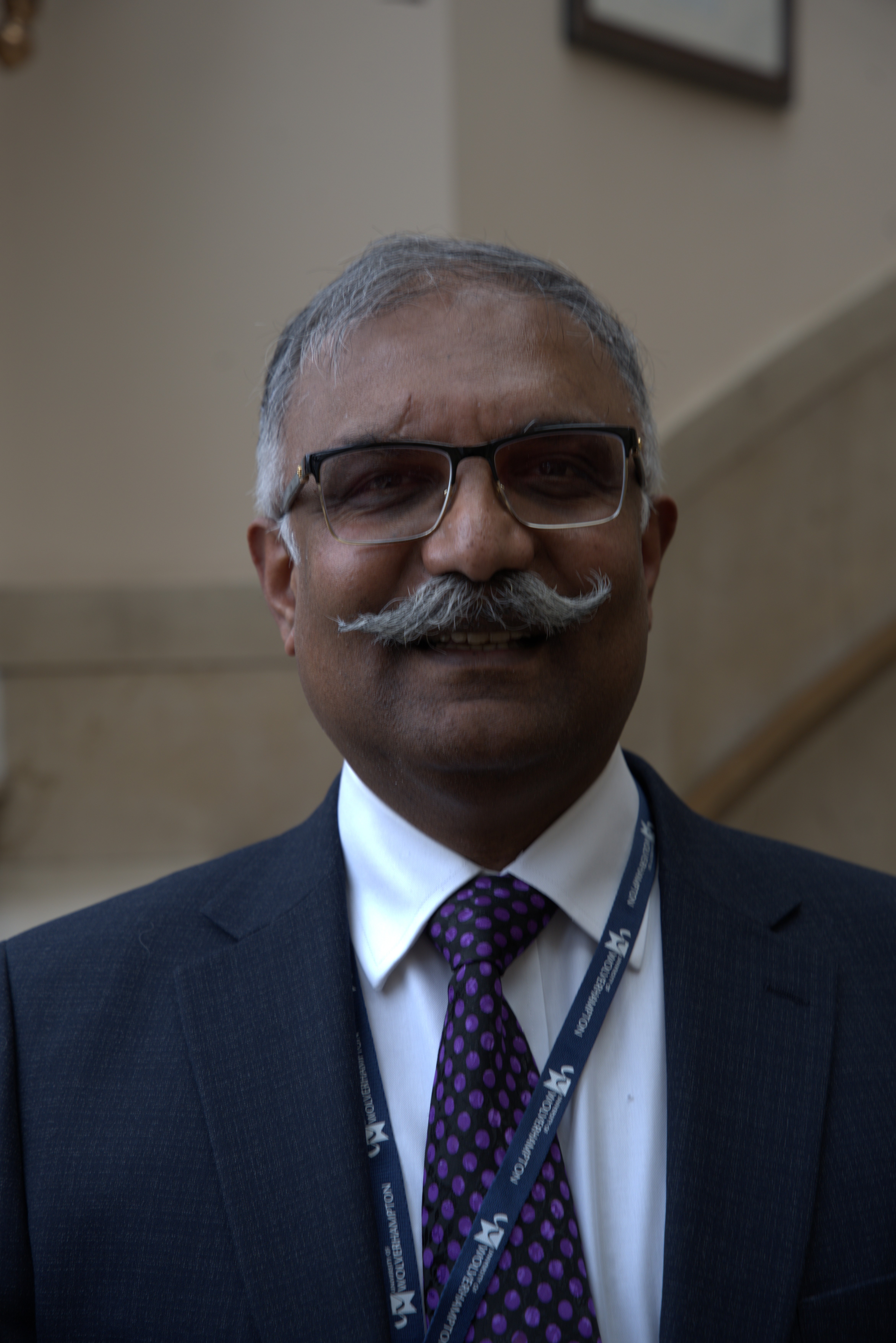 A man with a mustache and glasses