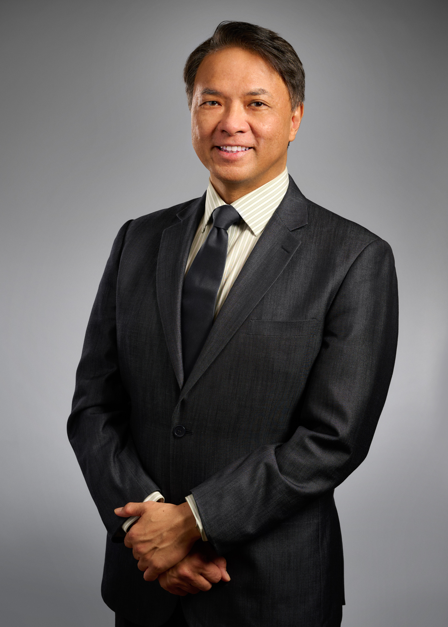 A man in a suit smiling