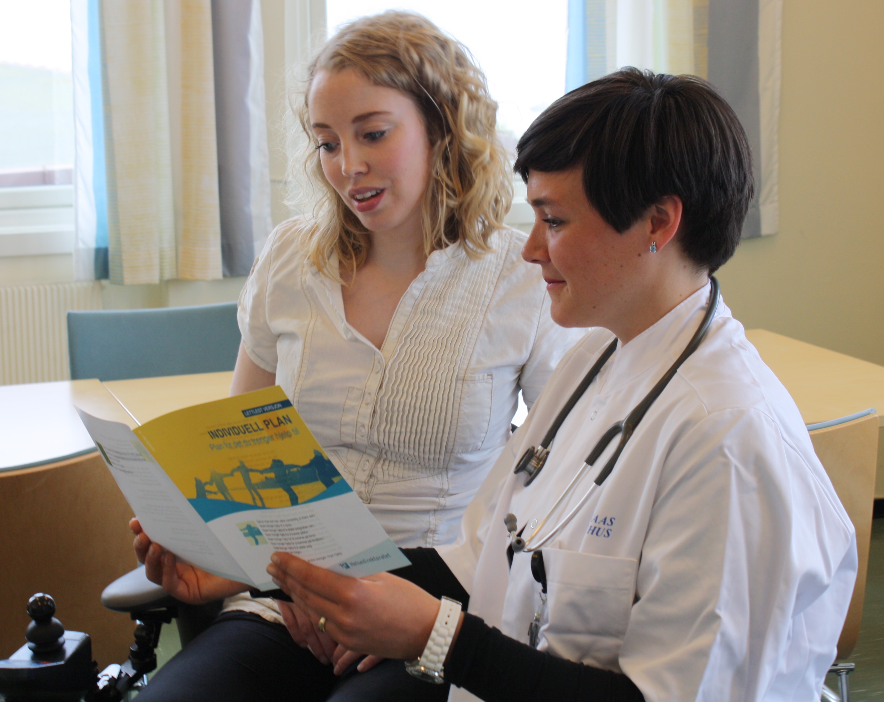A doctor showing a patient something on the book