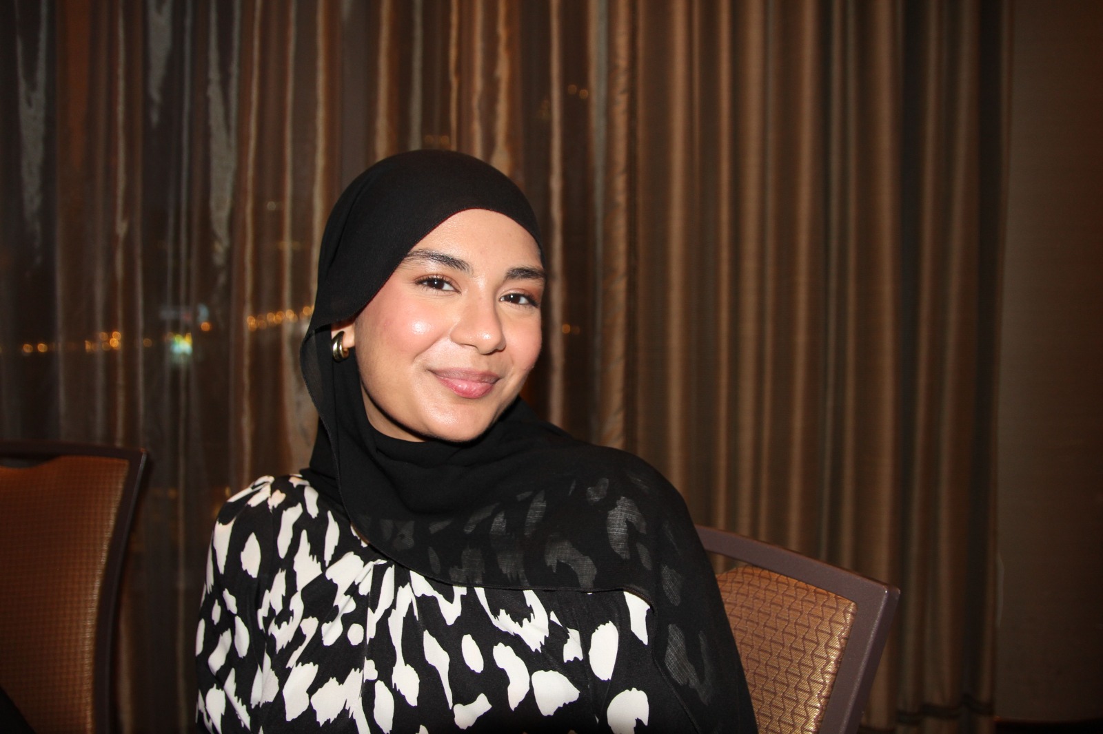 A woman wearing a black head scarf
