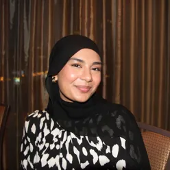 A woman wearing a black head scarf